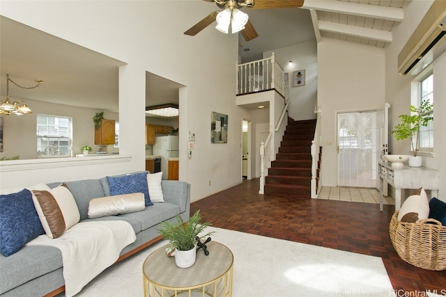 living room with beamed ceiling, parquet floors, and a healthy amount of sunlight