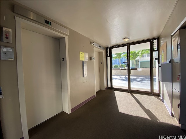 interior space with elevator and dark carpet