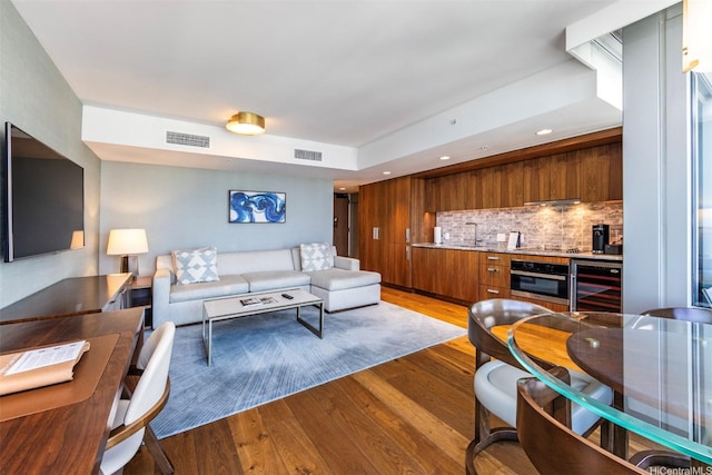 2139 Kuhio Ave Unit D2908, Honolulu, HI 96815 - living room featuring beverage cooler, light wood-type flooring, and recessed lighting