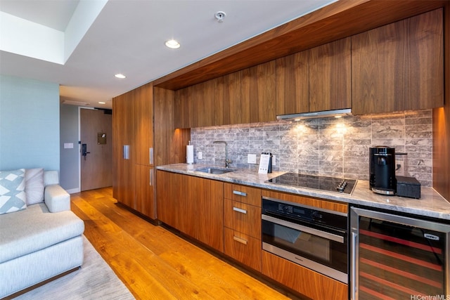 2139 Kuhio Ave Unit D2908, Honolulu, HI 96815 - kitchen featuring beverage cooler, black electric cooktop, brown cabinetry, modern cabinets, and recessed lighting