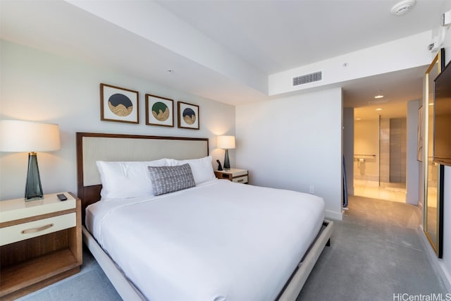 carpeted bedroom featuring ensuite bath