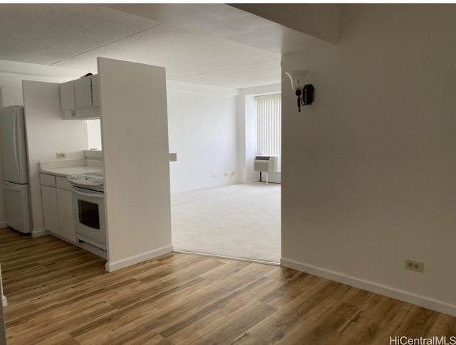 kitchen featuring hardwood / wood-style floors, white appliances, and gray cabinets