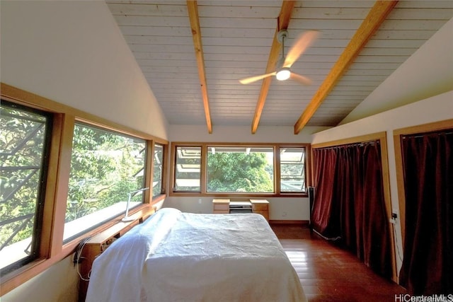 bedroom featuring multiple windows, dark wood-type flooring, and lofted ceiling with beams