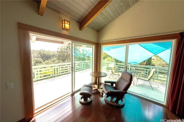 sunroom / solarium with a healthy amount of sunlight, lofted ceiling with beams, and wooden ceiling