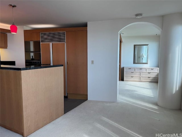 kitchen with pendant lighting and carpet flooring