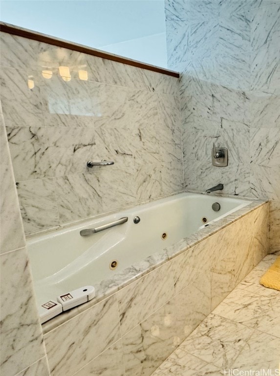 bathroom featuring tiled tub