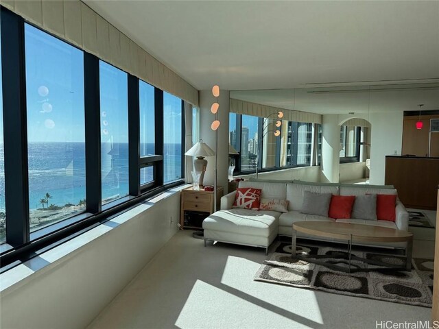 sunroom / solarium with a healthy amount of sunlight and a water view