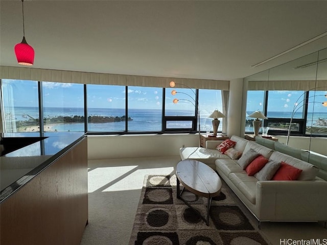 living room featuring carpet floors and a water view