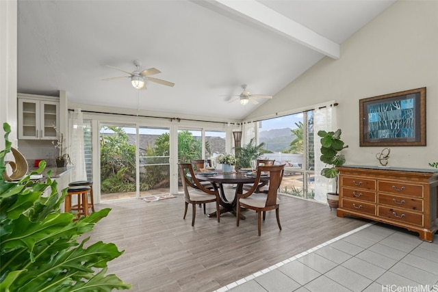 sunroom with lofted ceiling with beams and a ceiling fan