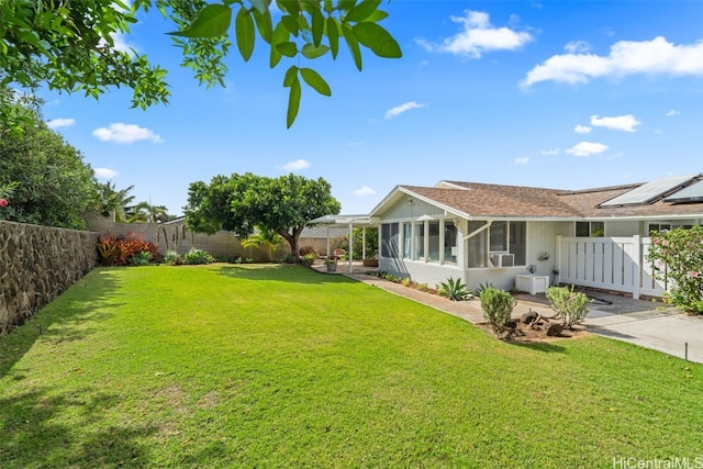 view of yard with cooling unit, a fenced backyard, and a sunroom