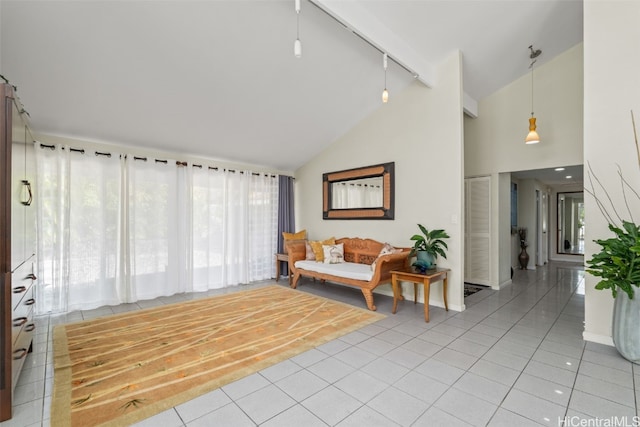 interior space featuring light tile patterned floors, high vaulted ceiling, and rail lighting