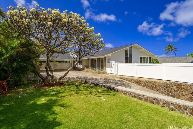 251 Kalalau St, Honolulu, HI 96825 - exterior space featuring driveway, stucco siding, fence, and a lawn