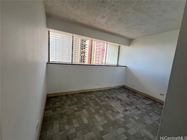 empty room with a textured ceiling