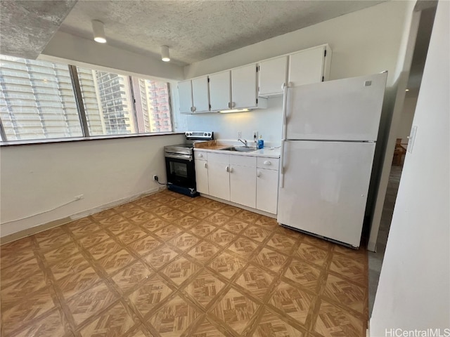 kitchen featuring electric range, sink, white fridge, a textured ceiling, and white cabinets