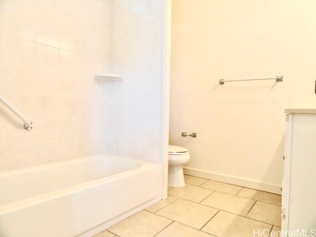 bathroom with tile patterned flooring, toilet, and tiled shower / bath