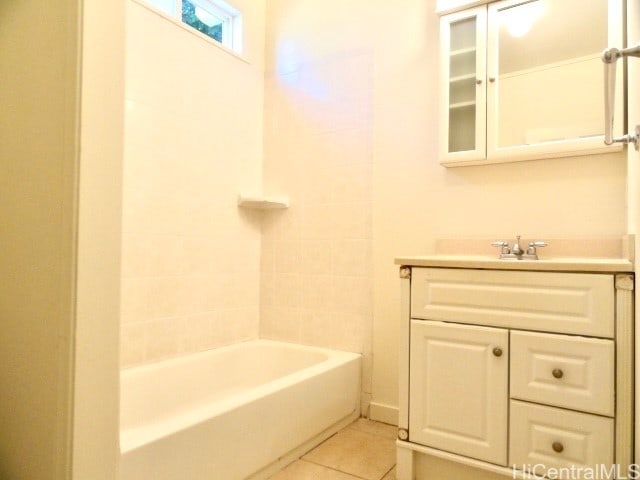 bathroom featuring bathing tub / shower combination, tile patterned flooring, and vanity