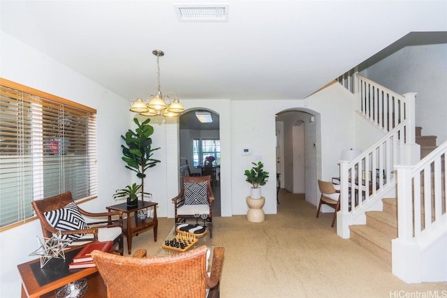 living area featuring carpet flooring and a chandelier