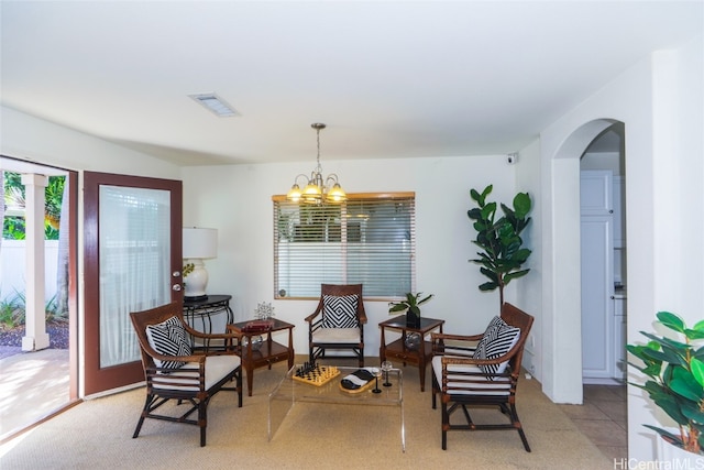 living area featuring light tile patterned floors and a chandelier