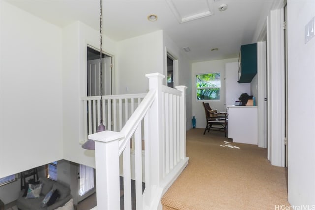 hallway featuring light colored carpet