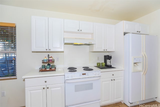 kitchen with white appliances and white cabinetry