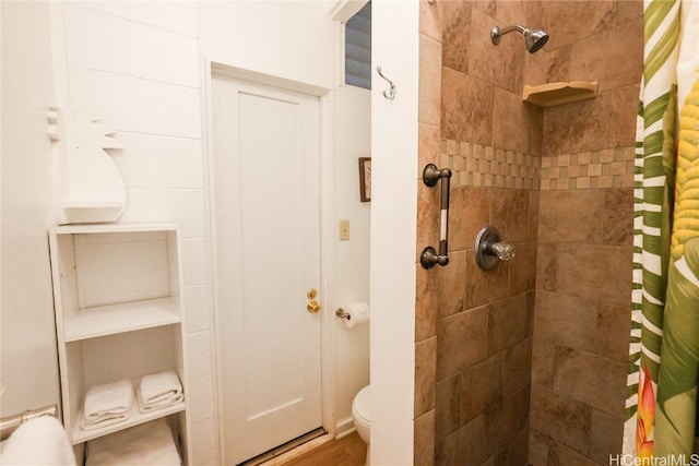 bathroom featuring hardwood / wood-style flooring, toilet, and walk in shower