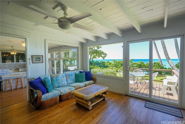 sunroom / solarium featuring beam ceiling, a water view, and ceiling fan