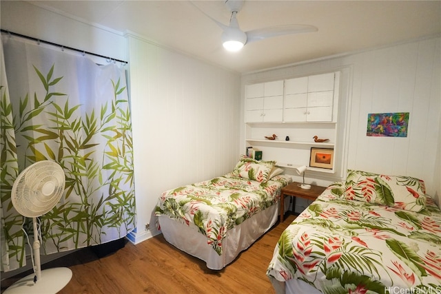 bedroom with ceiling fan and wood-type flooring