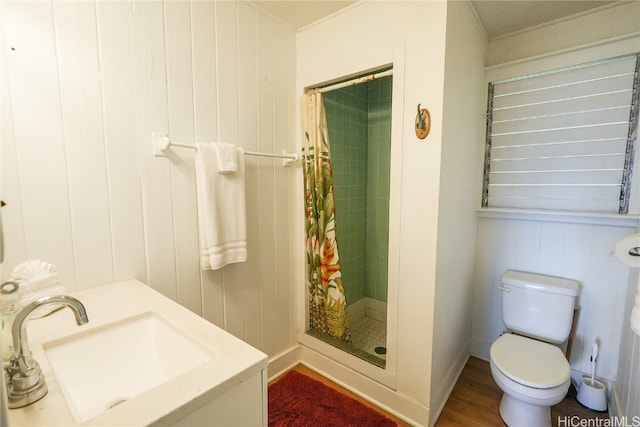 bathroom featuring toilet, walk in shower, wood walls, and sink