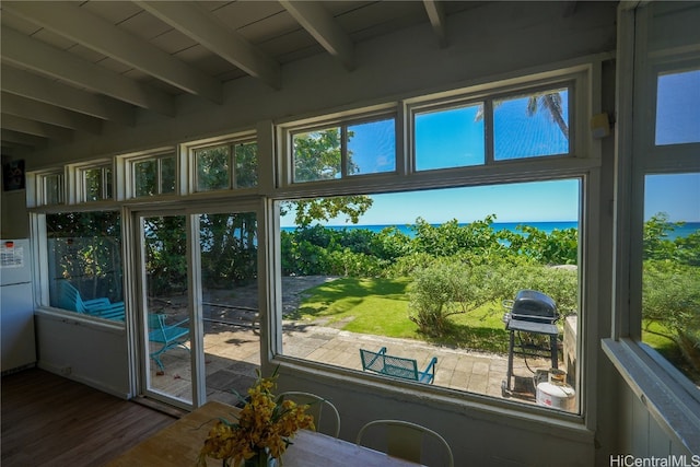 sunroom / solarium with a wealth of natural light and beamed ceiling