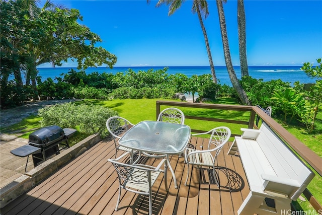 wooden terrace with a yard and a water view