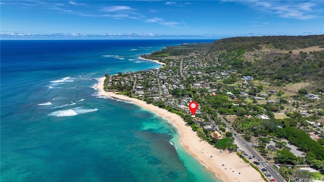 bird's eye view with a water view and a beach view