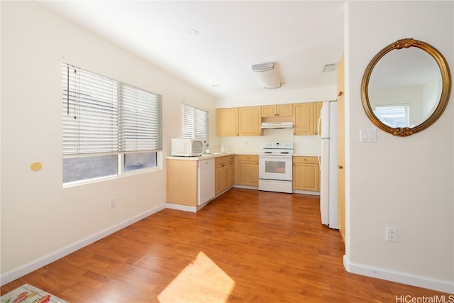 kitchen featuring light brown cabinets, white appliances, and light hardwood / wood-style floors