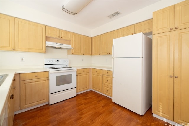 kitchen with dark wood-type flooring, exhaust hood, white appliances, and light brown cabinets