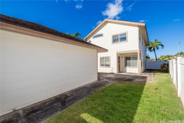 rear view of property with a yard and a patio