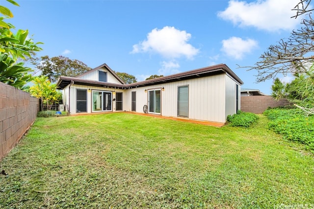 back of house with a lawn