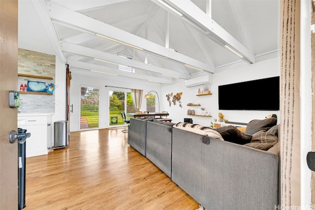 living room featuring beamed ceiling, a wall mounted air conditioner, light wood-type flooring, and high vaulted ceiling