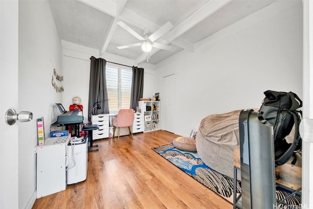 miscellaneous room featuring beam ceiling, ceiling fan, and hardwood / wood-style flooring