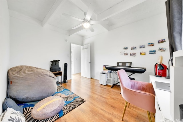 home office featuring beam ceiling, ceiling fan, and light wood-type flooring