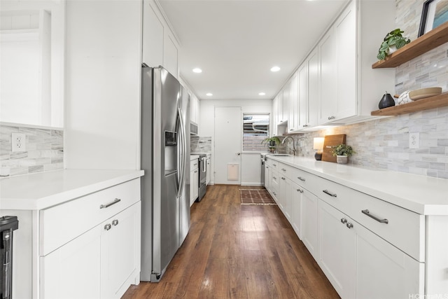 kitchen featuring white cabinets, stainless steel refrigerator with ice dispenser, dark wood-style floors, recessed lighting, and backsplash