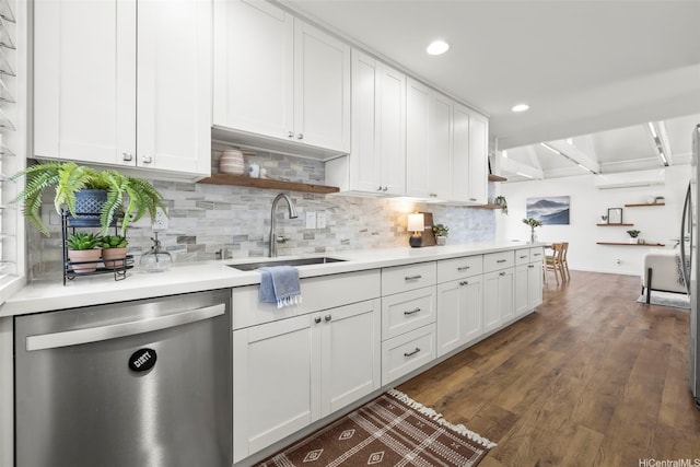 kitchen with tasteful backsplash, white cabinetry, open shelves, dishwasher, and a sink