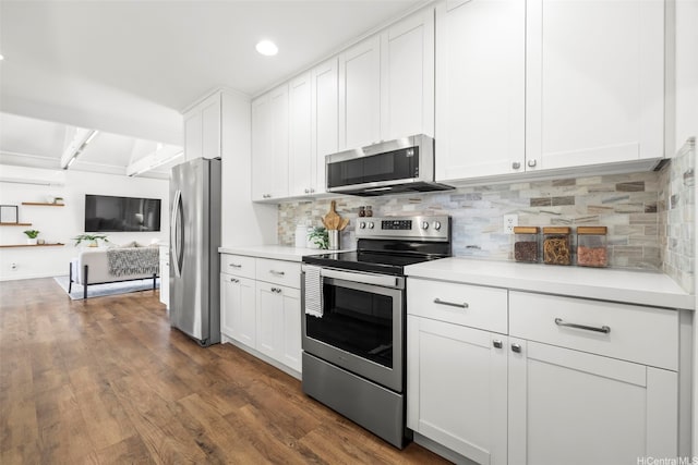 kitchen featuring appliances with stainless steel finishes, light countertops, and white cabinetry