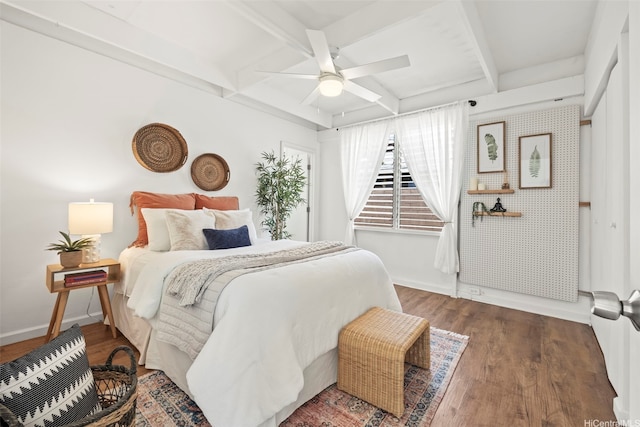 bedroom with beam ceiling, baseboards, coffered ceiling, and wood finished floors