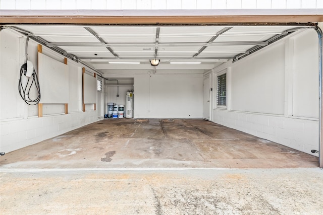 garage with water heater and a garage door opener