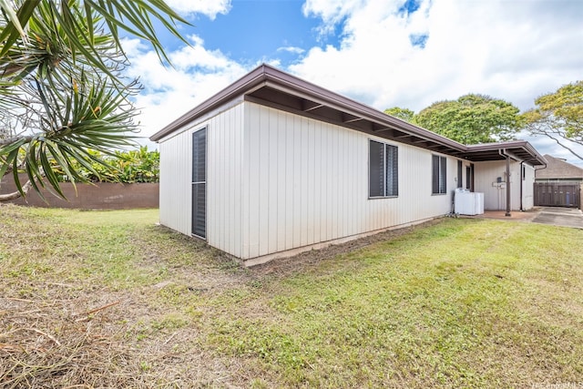 view of side of property featuring a yard and fence