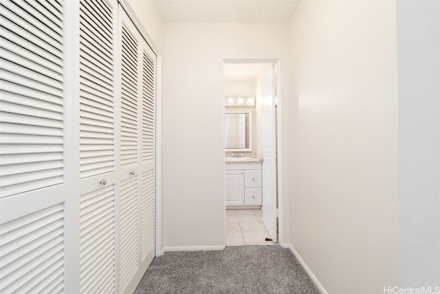 hall with light carpet and sink