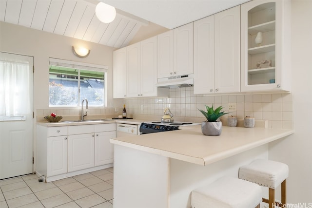 kitchen with white cabinetry, sink, white appliances, a breakfast bar, and light tile patterned flooring