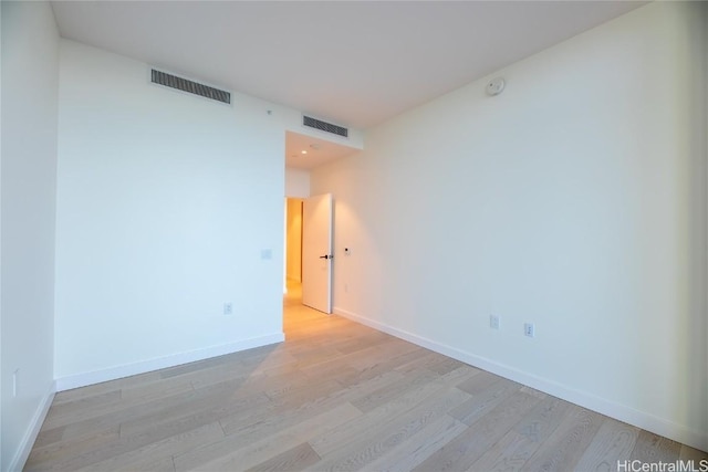 spare room featuring light hardwood / wood-style floors