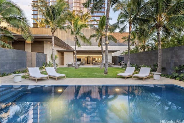 view of pool with a yard and a patio