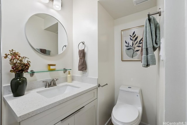 bathroom featuring vanity and toilet