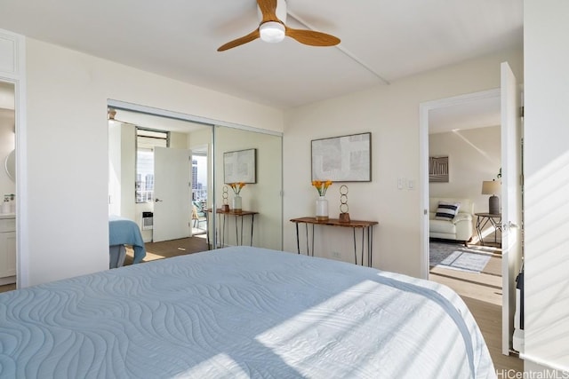 bedroom featuring a closet, ceiling fan, hardwood / wood-style floors, and ensuite bath